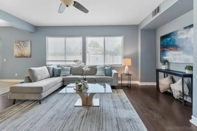 a living room with furniture and a wooden floor