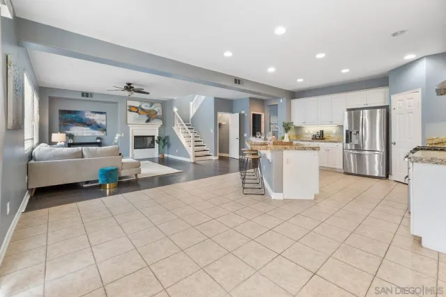 a living room with a couch and a refrigerator