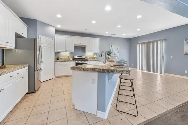 a kitchen with stainless steel appliances a refrigerator sink stove microwave and cabinets