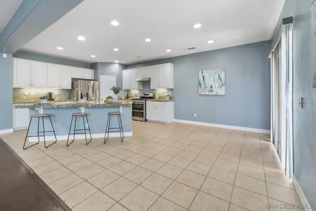 a kitchen with a cabinets and chairs in it