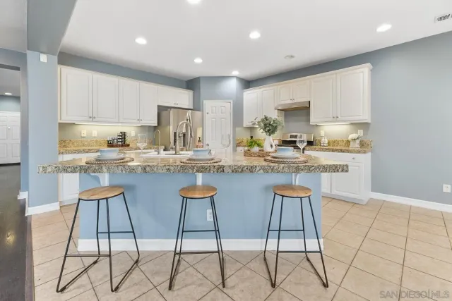 a kitchen with stainless steel appliances granite countertop a stove a sink and a cabinets