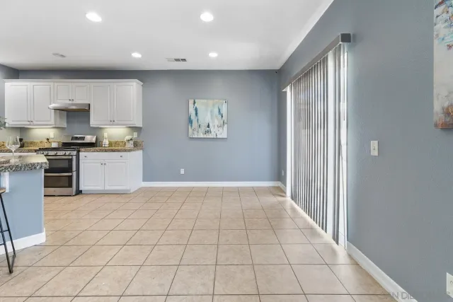 a kitchen with stainless steel appliances a refrigerator and a stove top oven