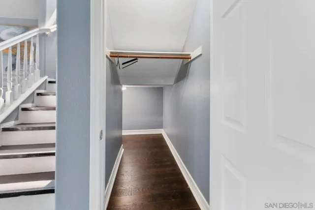 a view of a hallway with wooden floor and entryway