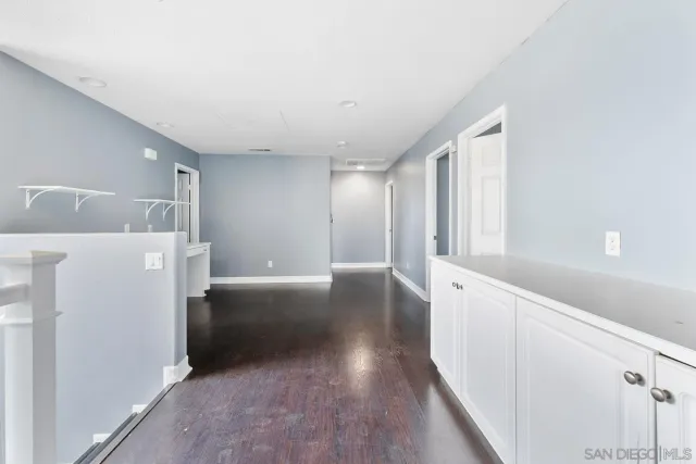 a view of a kitchen with a sink and refrigerator