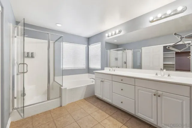 a spacious bathroom with a double vanity sink mirror and double