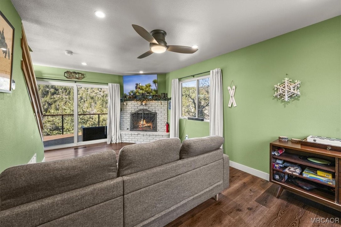 33334 Bear Road Running Springs, CA 92382 - Photo 15 of 37 a living room with furniture a fireplace and a flat screen tv