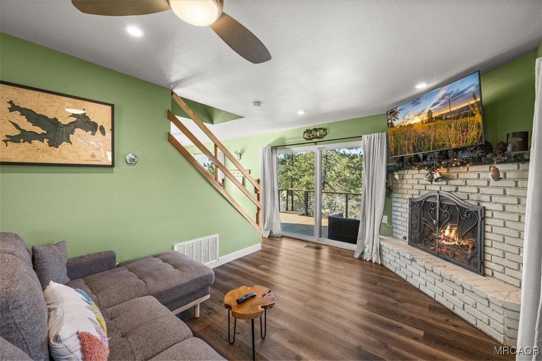 33334 Bear Road Running Springs, CA 92382 - Photo 16 of 37 a living room with furniture a flat screen tv and a fireplace