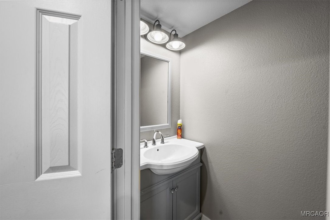 33334 Bear Road Running Springs, CA 92382 - Photo 18 of 37 a bathroom with a sink and a mirror