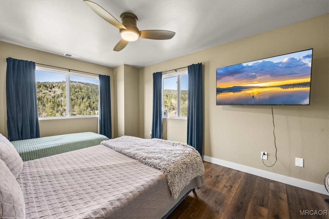 33334 Bear Road Running Springs, CA 92382 - Photo 24 of 37 a bedroom with a bed and a painting on the wall