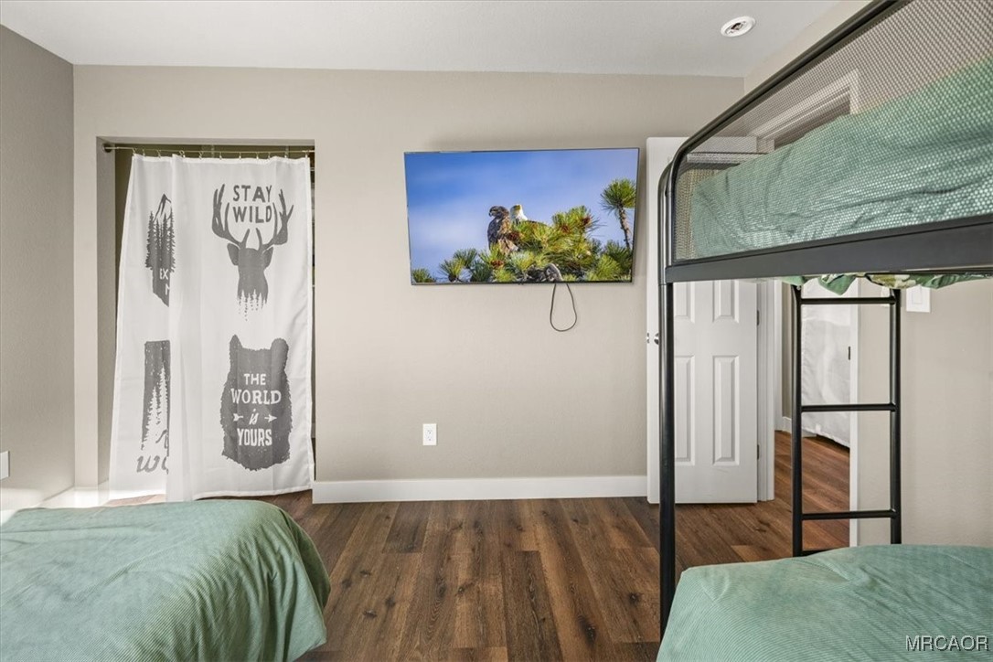 33334 Bear Road Running Springs, CA 92382 - Photo 29 of 37 a bedroom with a bed and a painting on the wall