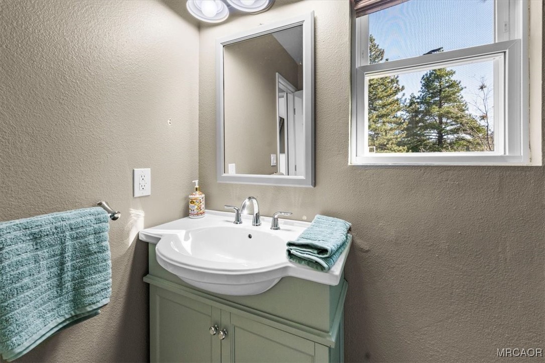 33334 Bear Road Running Springs, CA 92382 - Photo 31 of 37 a bathroom with a sink and a mirror