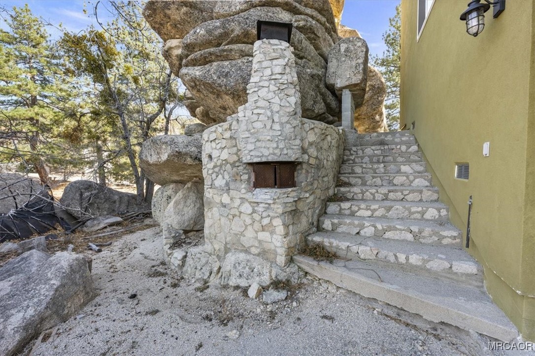 33334 Bear Road Running Springs, CA 92382 - Photo 37 of 37 a stone house with a outdoor space