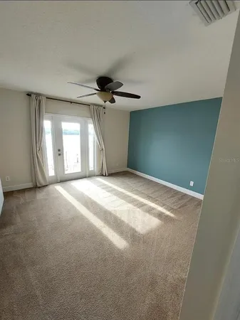 a view of a livingroom with a ceiling fan and window