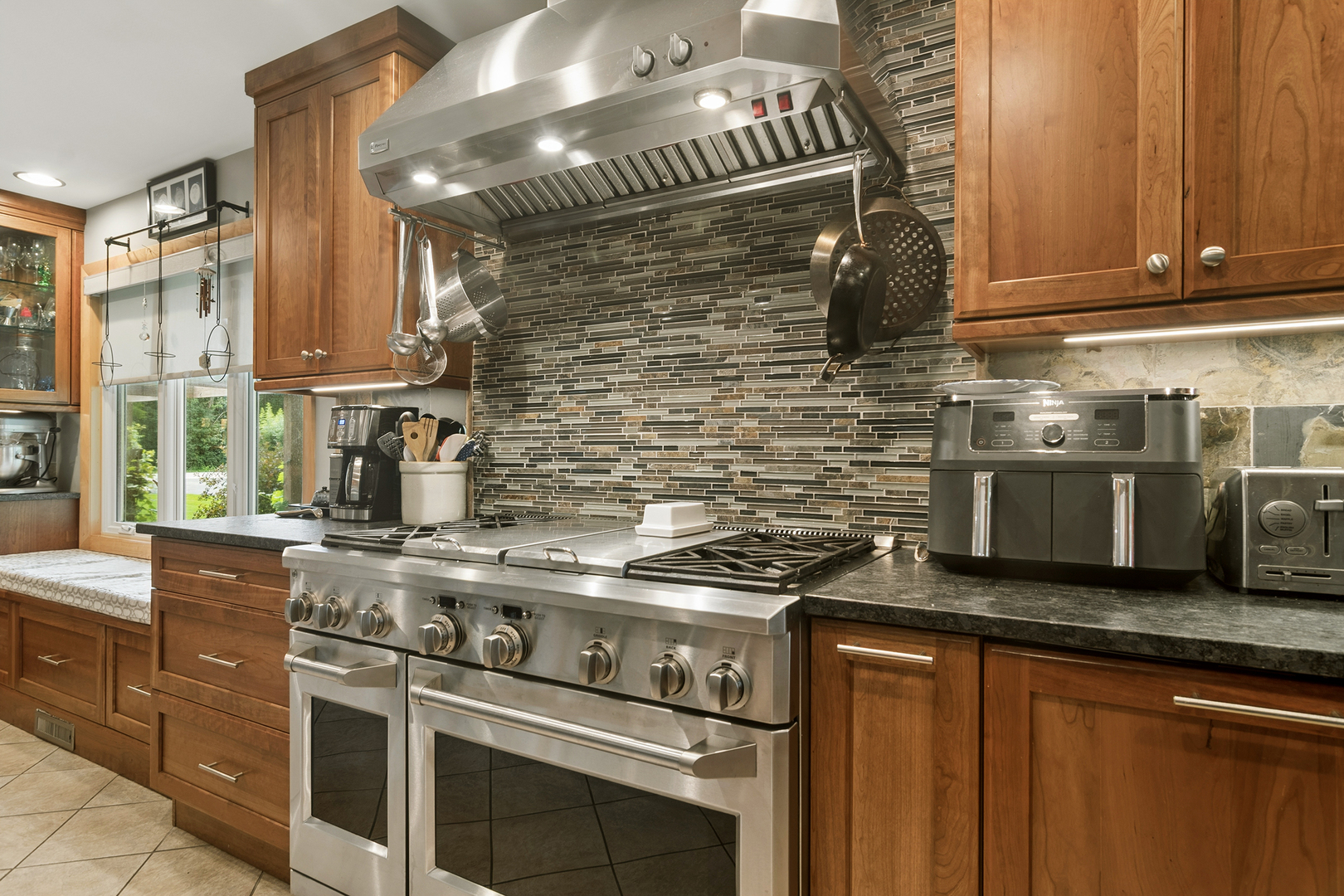170 South Ela Road Barrington, IL 60010 - Photo 8 of 33 a kitchen with stainless steel appliances granite countertop a stove and a microwave