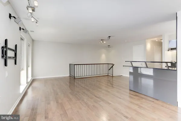 a view of staircase and white walls with wooden floor