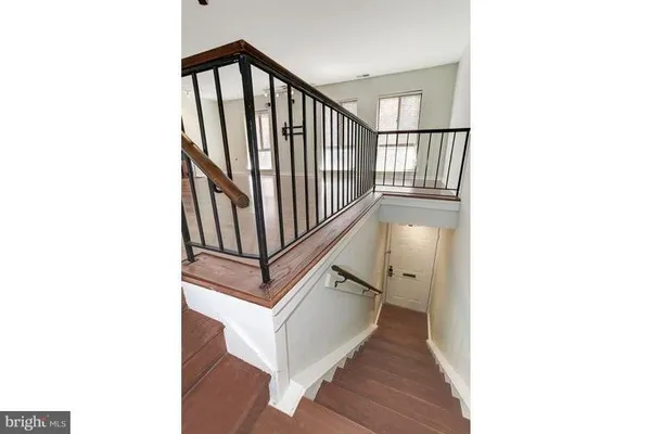 a view of a staircase with white walls