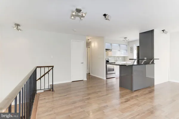 a view of kitchen with wooden floor and electronic appliances