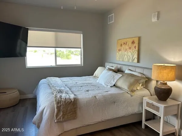 a bedroom with a bed and a mirror