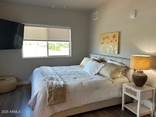 a bedroom with a bed and a mirror