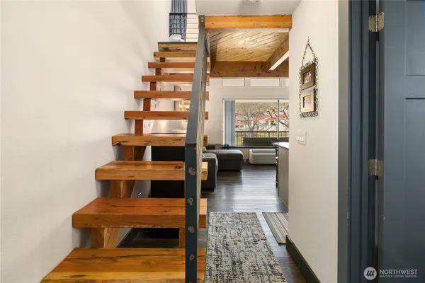 a view of entryway livingroom and hall with wooden floor