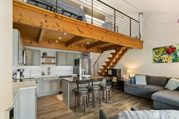 a living room with furniture and kitchen view