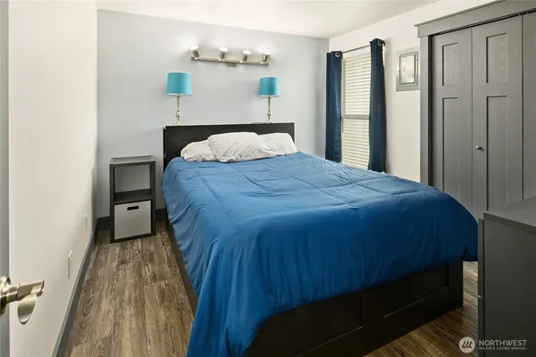a bedroom with a bed and a night stand