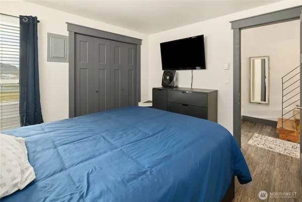 a bedroom with a bed and a flat screen tv