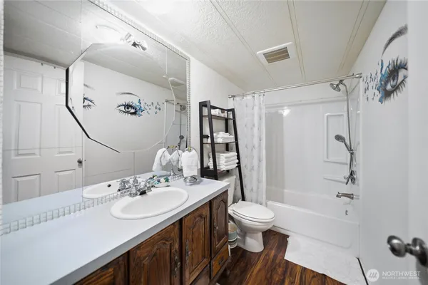 a bathroom with a sink a toilet and shower