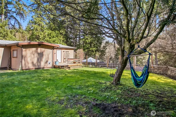 a view of a house with backyard and sitting area