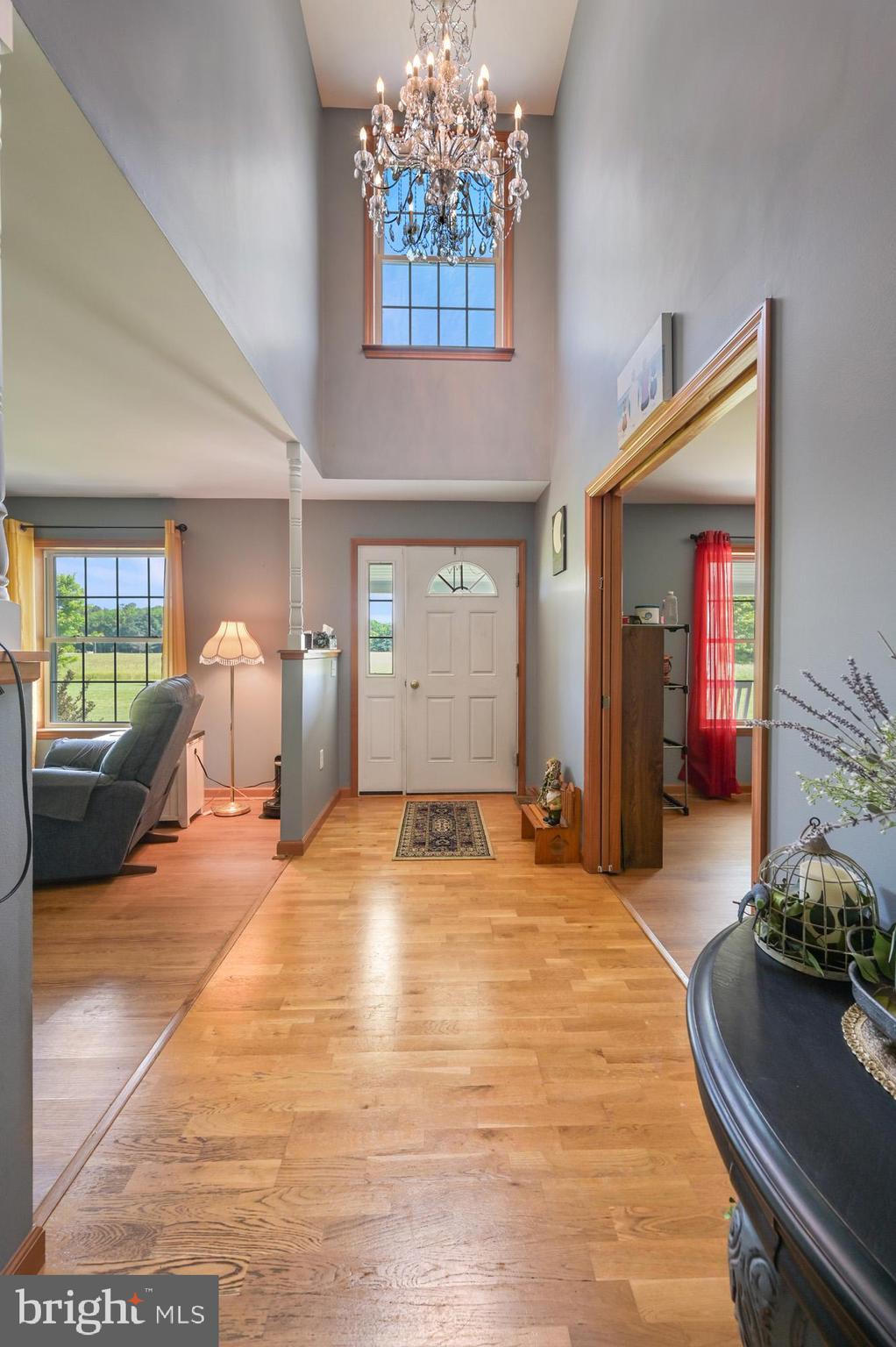 480 Hemping Road Harrington, DE 19952 - Photo 13 of 40 a spacious bedroom with a large bed and a chandelier