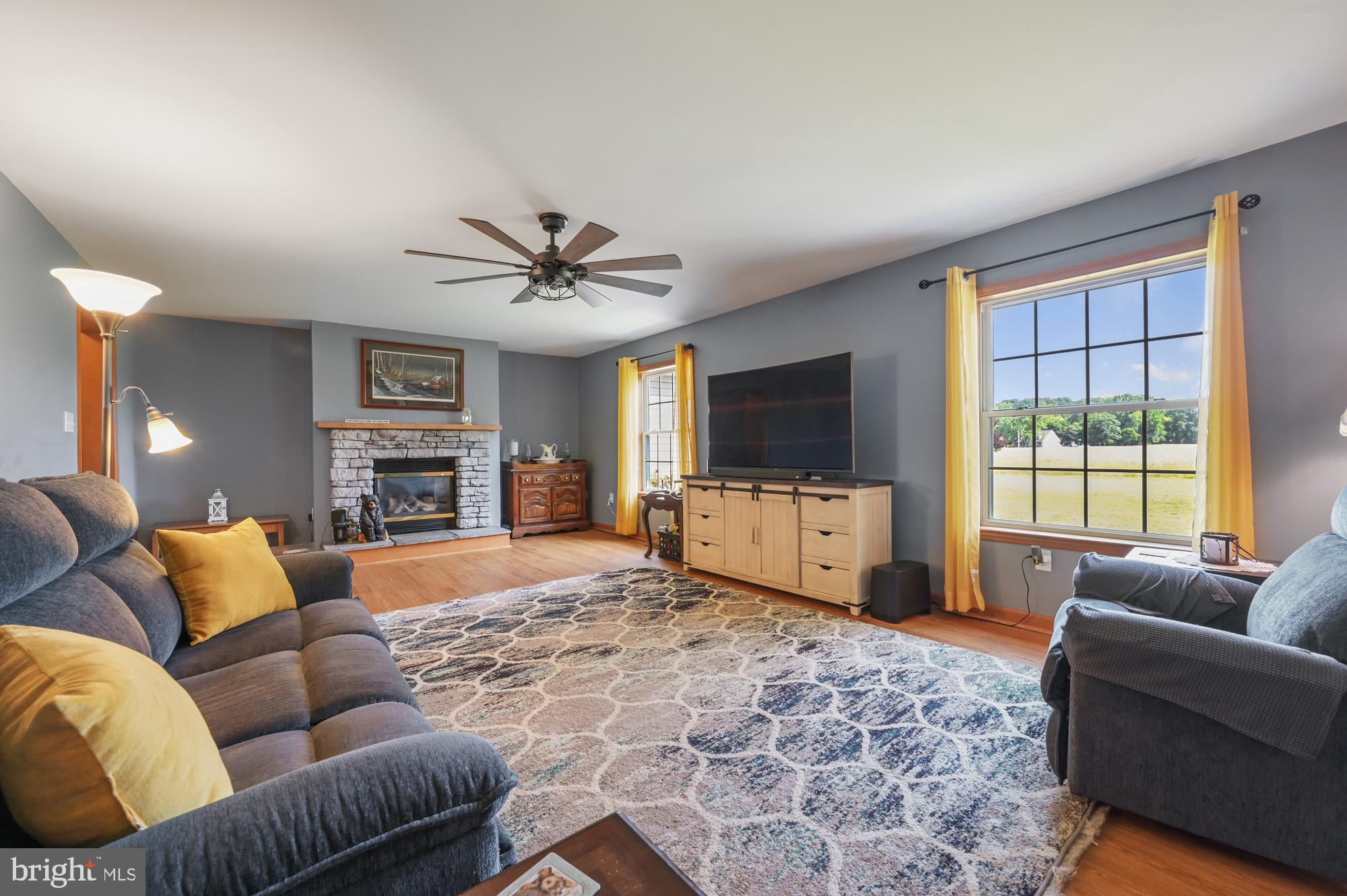480 Hemping Road Harrington, DE 19952 - Photo 17 of 40 a living room with furniture a flat screen tv and a large window