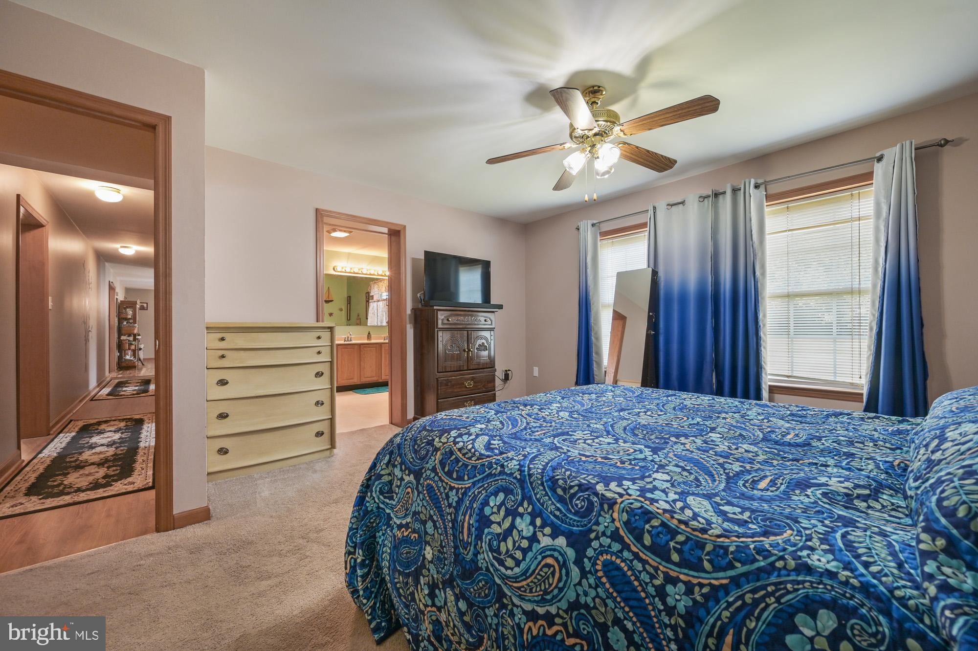 480 Hemping Road Harrington, DE 19952 - Photo 31 of 40 a bedroom with a bed and a chandelier