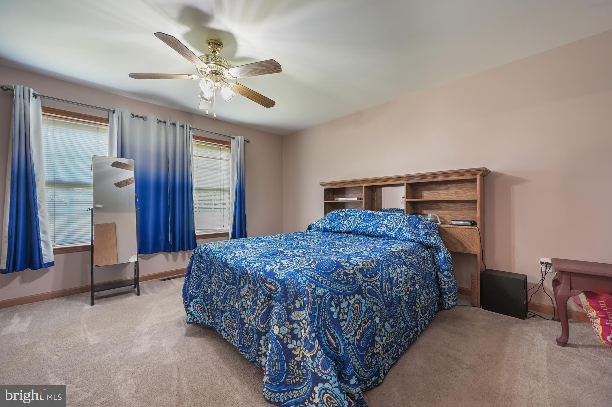 480 Hemping Road Harrington, DE 19952 - Photo 32 of 40 a bedroom with a bed and a chandelier