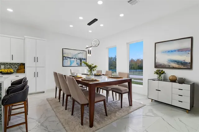 a view of a dining room with furniture and window