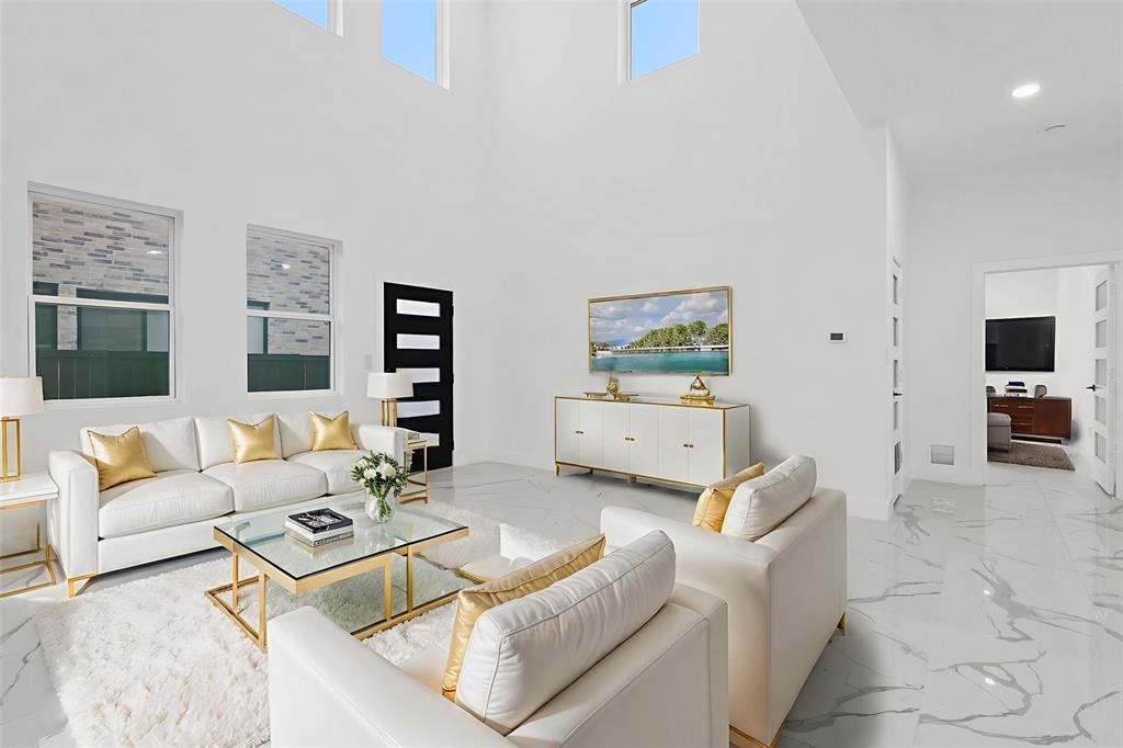 9726 Sunset Drive Frisco, TX 75033 - Photo 4 of 12 a living room with furniture and a flat screen tv