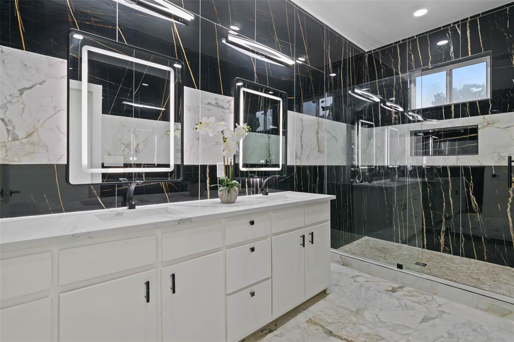 9726 Sunset Drive Frisco, TX 75033 - Photo 6 of 12 a bathroom with a double vanity sink a mirror and shower