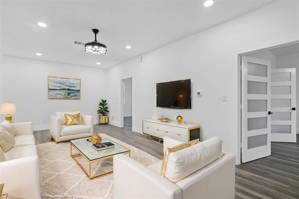 9726 Sunset Drive Frisco, TX 75033 - Photo 9 of 12 a living room with furniture a flat screen tv and kitchen view