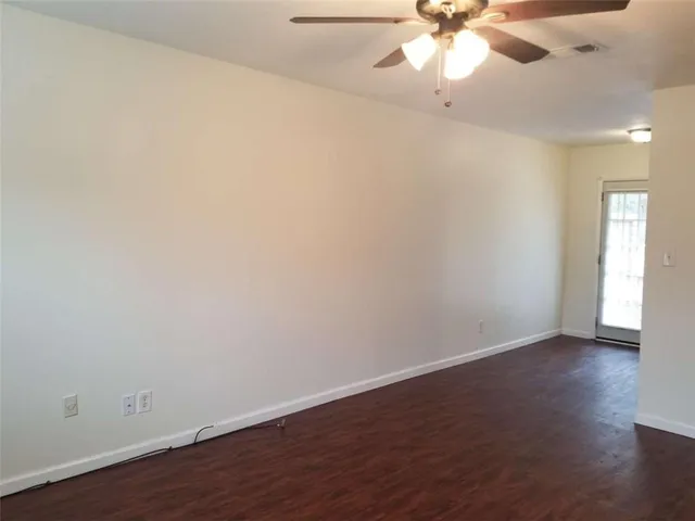 a view of an empty room and wooden floor