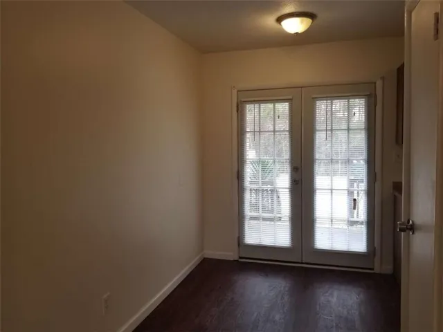 a view of wooden floor and windows in a room