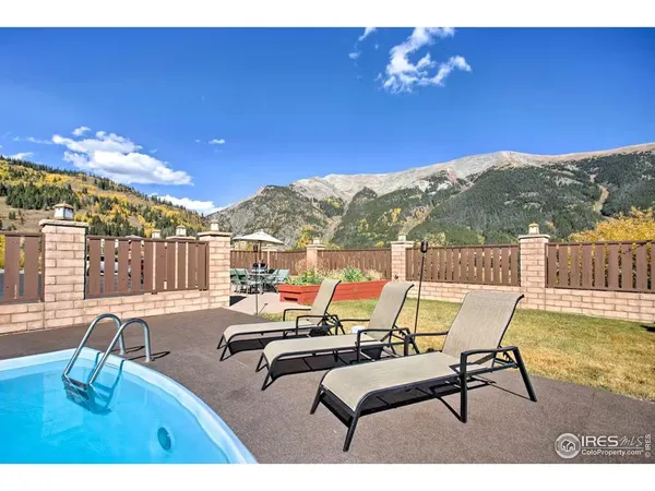 a view of a swimming pool with a table and chairs