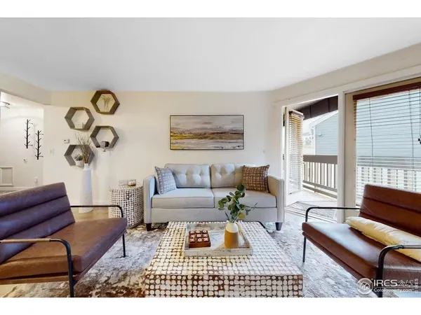 a living room with furniture a rug and a window
