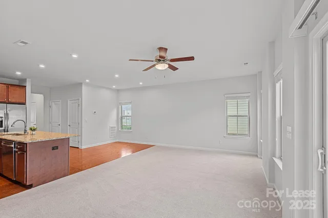 a view of a kitchen with a sink a ceiling fan and kitchen view