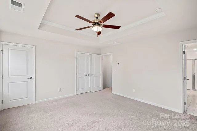a view of an empty room with a ceiling fan