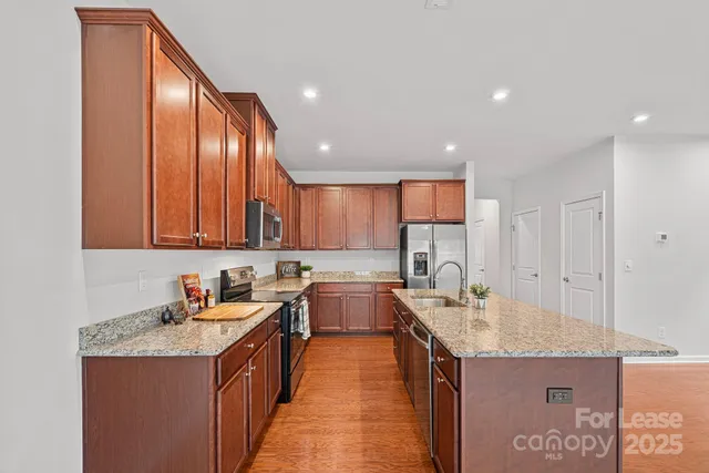 a kitchen with a sink stove and cabinets