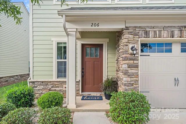 a front view of a house with potted plants