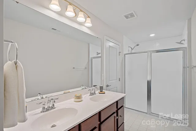 a bathroom with a sink tub and a mirror
