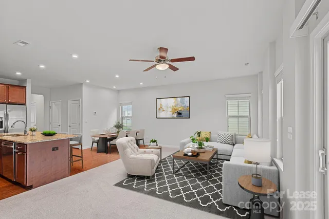 a living room with furniture a chandelier and a window