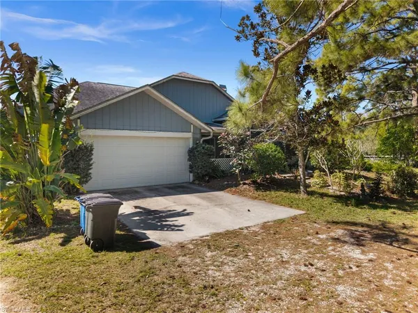 a wooden bench sitting in middle of a yard