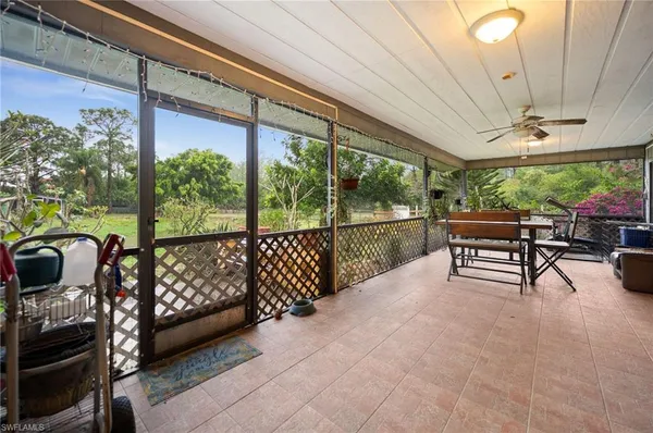 a view of a porch with furniture and garden