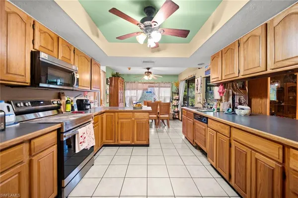 a large kitchen with stainless steel appliances lots of counter space and a sink